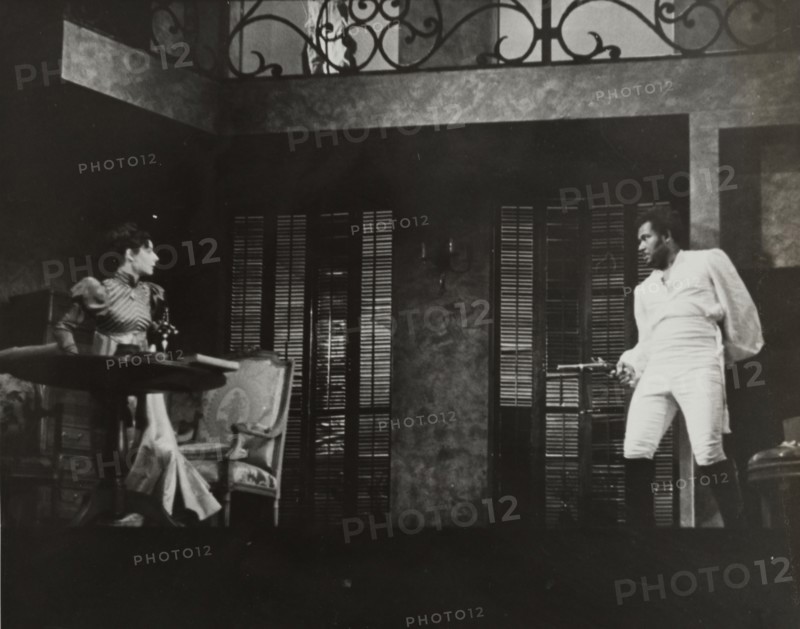 Rex Ingram pointing gun at woman, 1938.