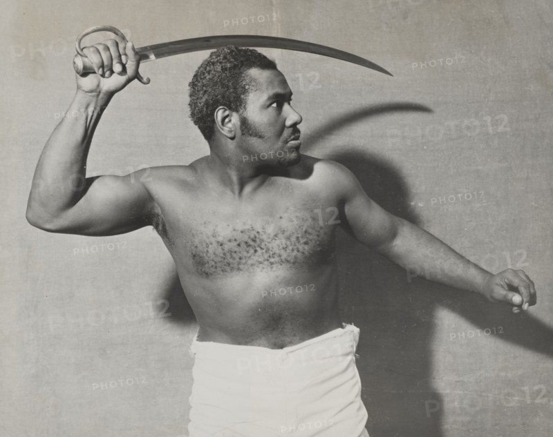 Rex Ingram, shirtless, with cutlass, 1938.