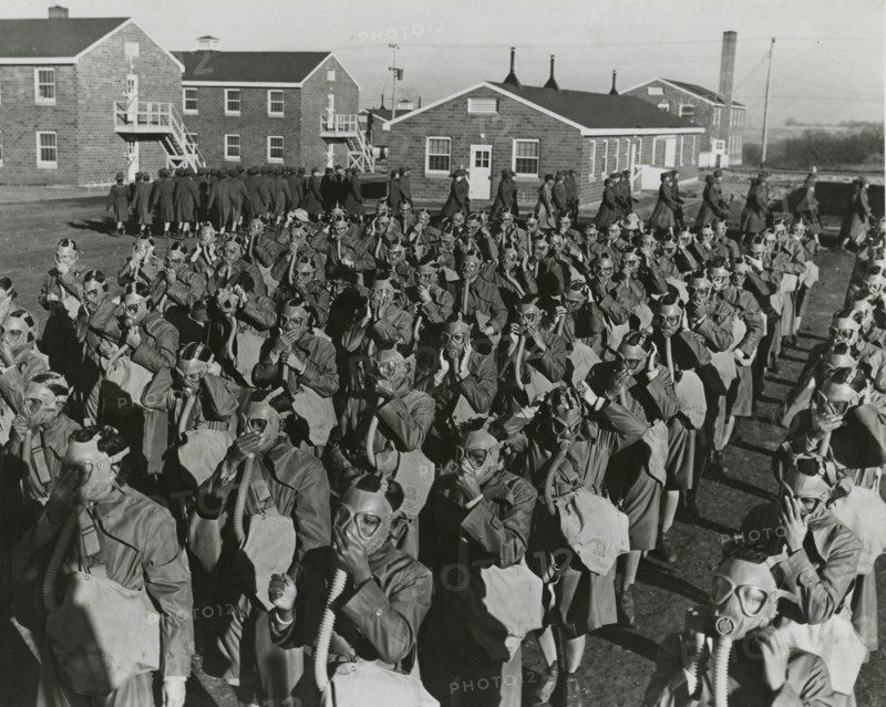 Members of the Women's Army Auxiliary Corps wearing gas masks and testing them for..., 1943. Creator: Unknown.