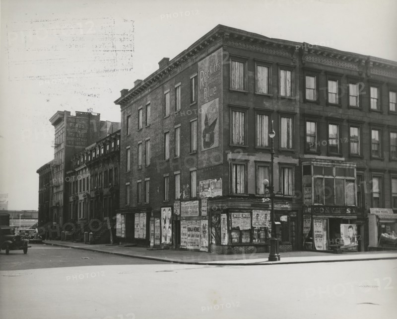 Boarded residential building on the corner of Madison Avenue and East 133rd Street, Harlem, New York City, 1938.