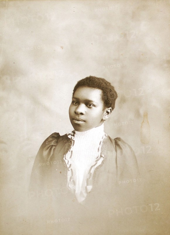 Studio portrait of young woman, c1890-c1899. Creators: M Yogg, Unknown.