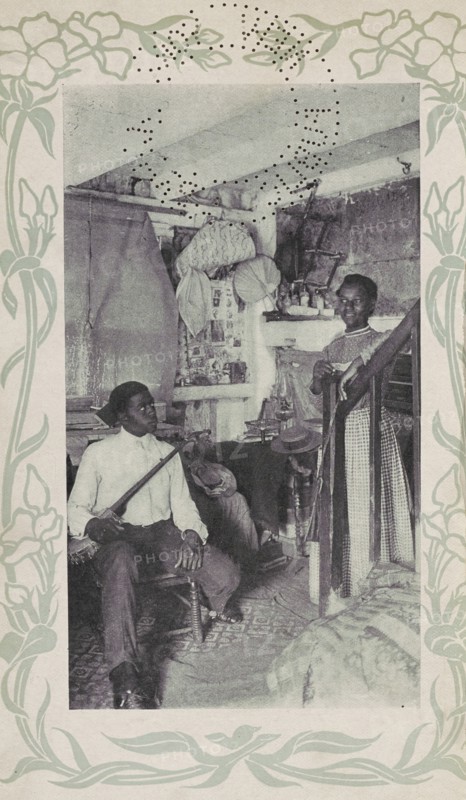 Man seated with banjo next to woman at stairs, 1903. Creator: Camera Club.