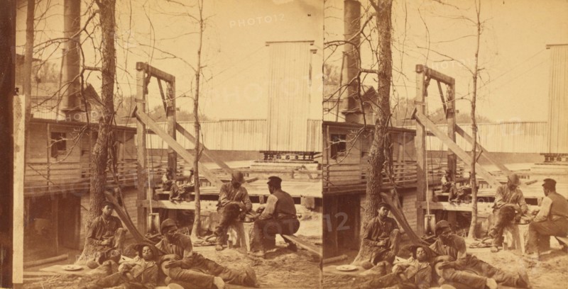 North Carolina. Negro boatmen at lunch, c1850-c1930. Creator: Rufus Morgan.
