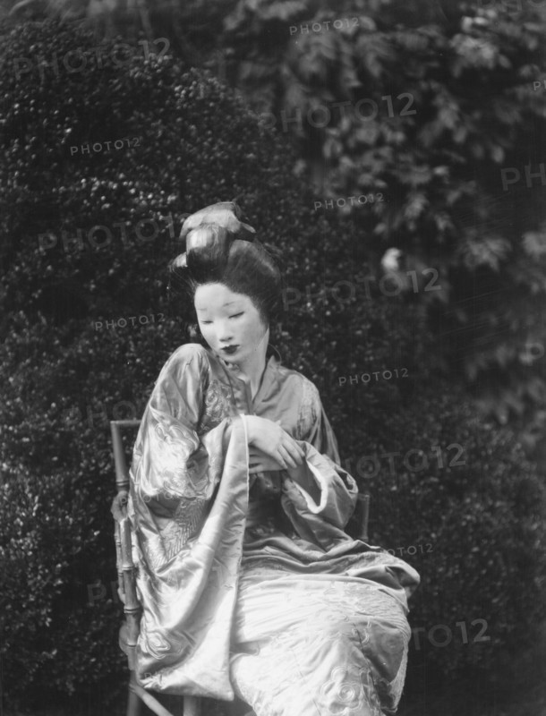 Person wearing a mask made by W.T. Benda, 1925 Sept. 20. Creator: Arnold Genthe.