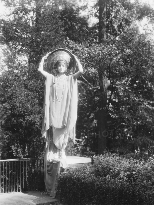 Person wearing a mask made by W.T. Benda, 1925 Sept. 20. Creator: Arnold Genthe.
