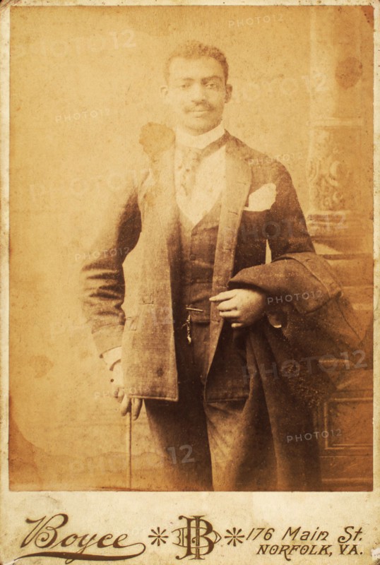 Dapper man, coat draped over his arm, and cane in hand, c1880-c1889. Creator: Unknown.