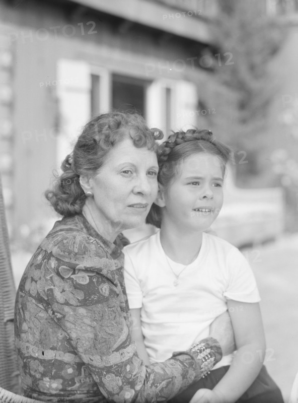 Churchill, Mrs., with child Orrin, seated outdoors, not before 1932 Mar. Creator: Arnold Genthe.