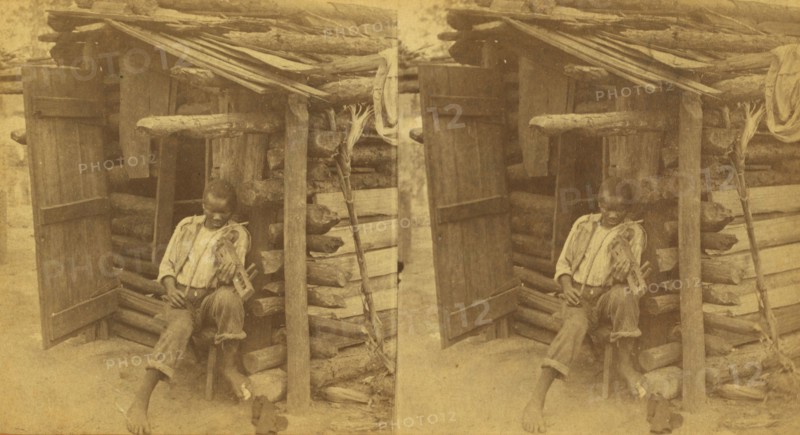 Happy little Bob. [Man playing fiddle in front of cabin], (1868-1900?). Creator: O. Pierre Havens.