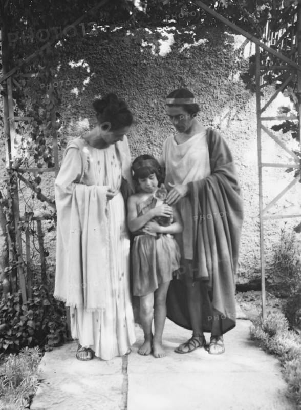 Kanellos, Vanellos and Tanagra, and child holding a cat, in dance costumes, 1929 Creator: Arnold Genthe.