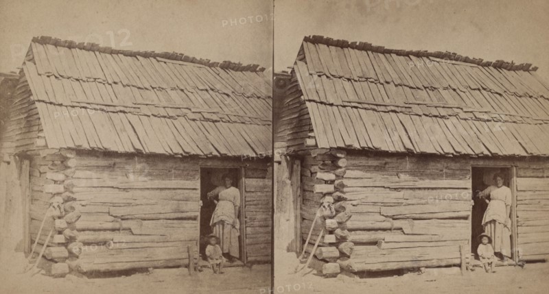 Happy little nig. [Woman and a small child in a cabin doorway], (1868-1900?). Creator: O. Pierre Havens.