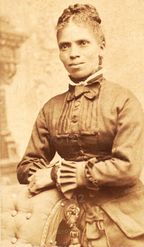 Studio portrait of unidentified woman, arms on back of chair, c1880-c1889. Creator: Richmond Photograph Co.
