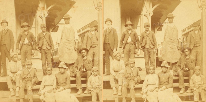 Simplicity, Alabama, U.S.A. [Group gathered on a porch, in town], (1868-1900?). Creator: Benjamin West Kilburn.