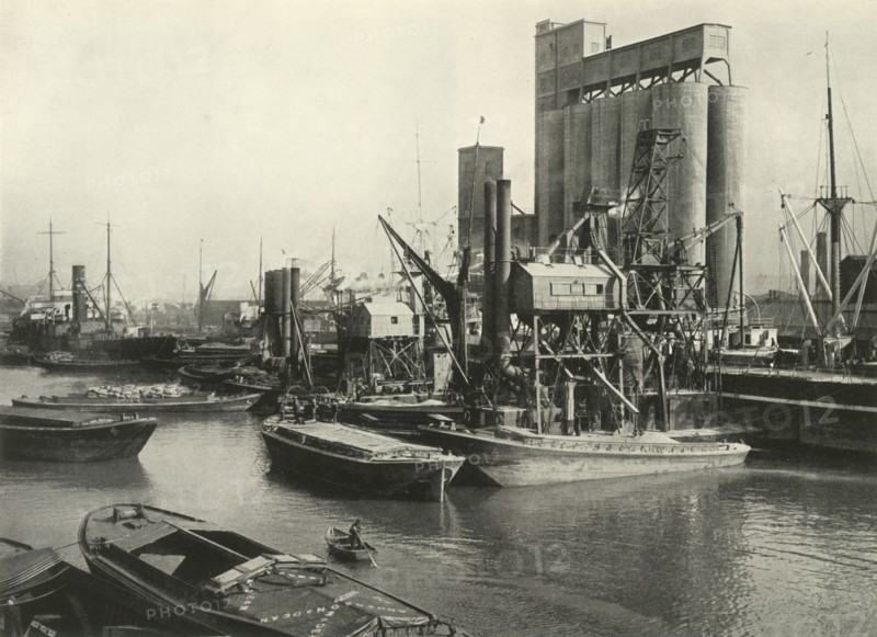 Factories, Refineries, Granaries Grow Thick Ship Discharging Grain by Floating Pneumatic...', 1937 Creator: J Dixon-Scott.