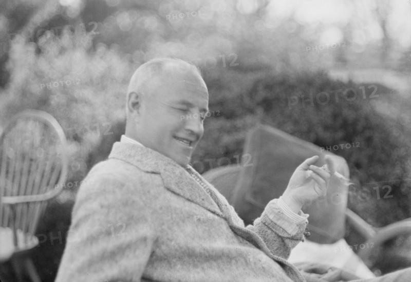 Clucas, E.W., seated outdoors, 1931 June 14. Creator: Arnold Genthe.