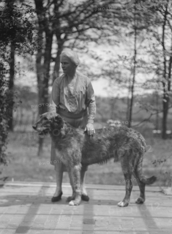 Noland, Charlotte, Miss, with dog, standing outdoors, 1931 May 8. Creator: Arnold Genthe.