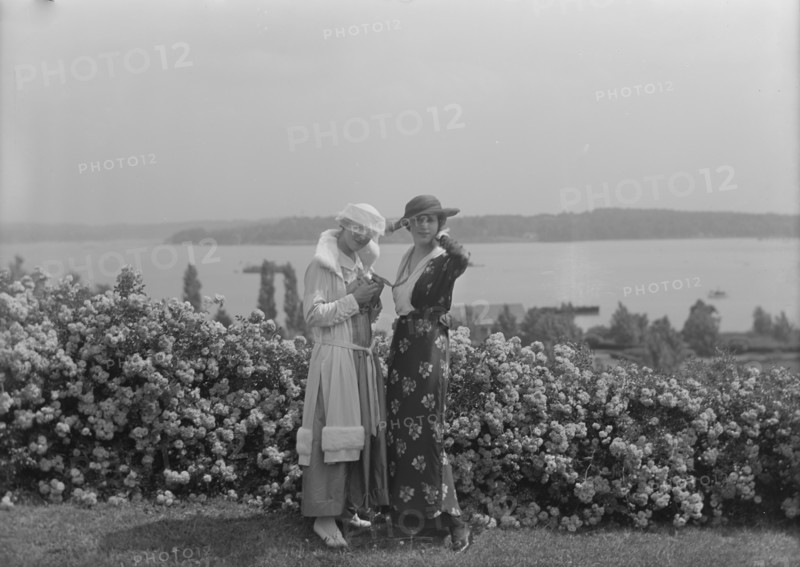 Viola Kraus and Helen Freeman standing outdoors, 1915 June. Creator: Arnold Genthe.
