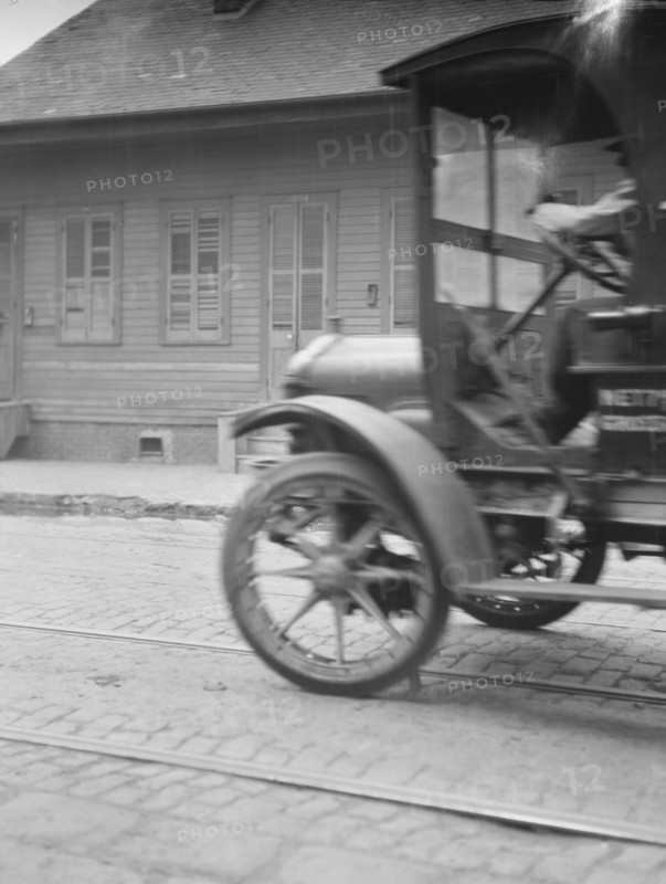 Car driving down a street, New Orleans or Charleston, South Carolina, between 1920 and 1926. Creator: Arnold Genthe.