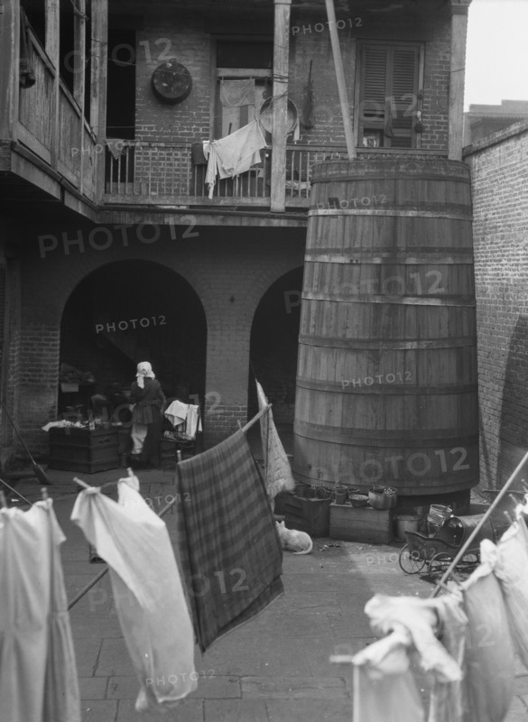 Courtyard with hanging laundry, New Orleans, between 1920 and 1926. Creator: Arnold Genthe.