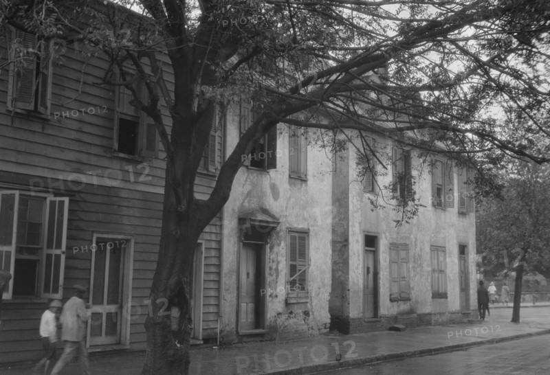 Facades of two-story houses, [Alexander Peronneau Tenements, 141 Church Street..., c1920-1926. Creator: Arnold Genthe.