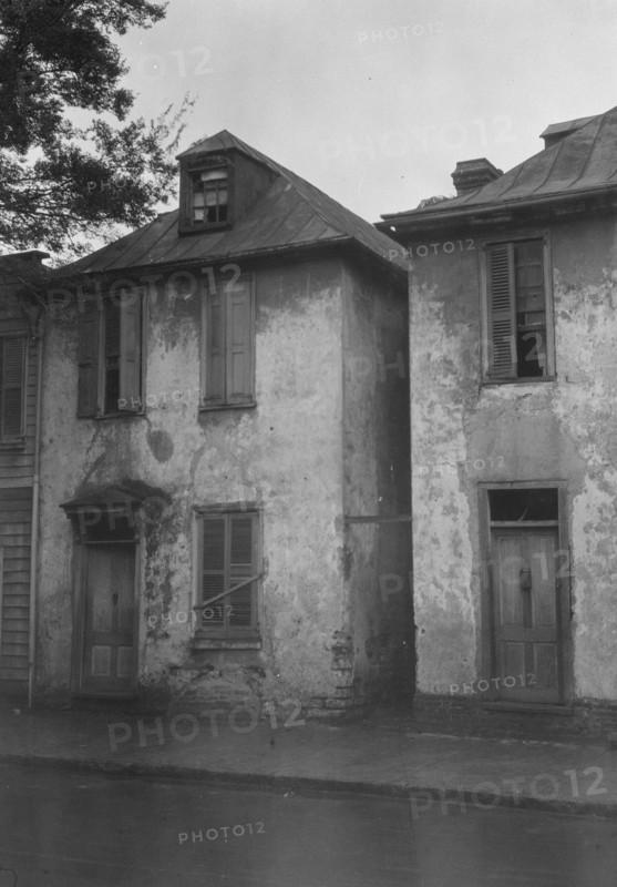Facades of two-story houses, [Alexander Peronneau Tenements, 141 Church Street..., c1920-1926. Creator: Arnold Genthe.