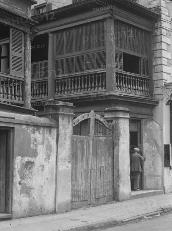 Multi-story house behind gated wall, New Orleans or Charleston, South Carolina, c1920-1926. Creator: Arnold Genthe.