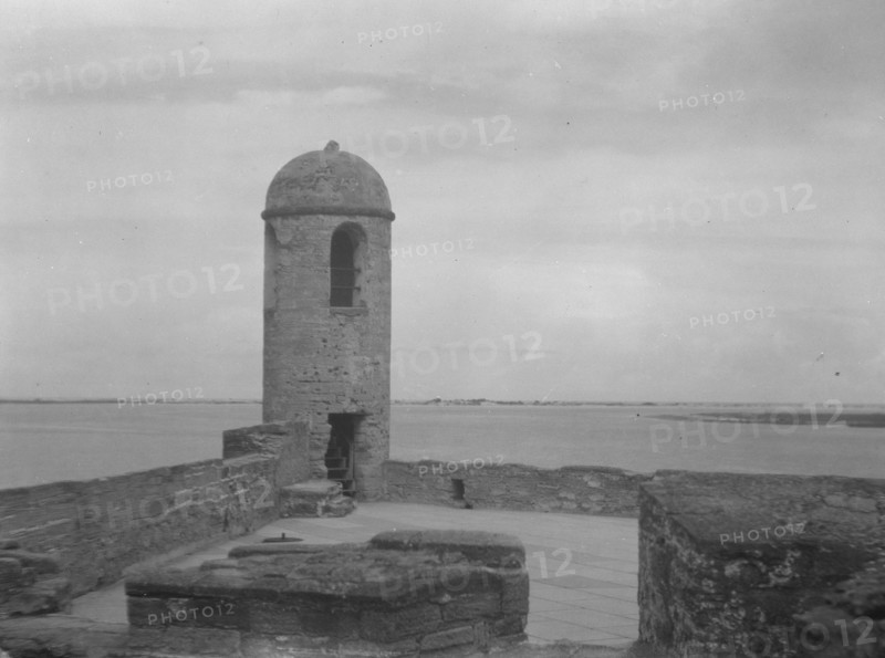 Walls and round tower by the water, Castillo de San Marcos, St. Augustine, Florida, c1920-c1926. Creator: Arnold Genthe.