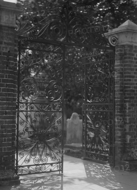 Gates on Broad Street to the graveyard at St. Michael's Episcopal Church, Charleston..., c1920-1926. Creator: Arnold Genthe.
