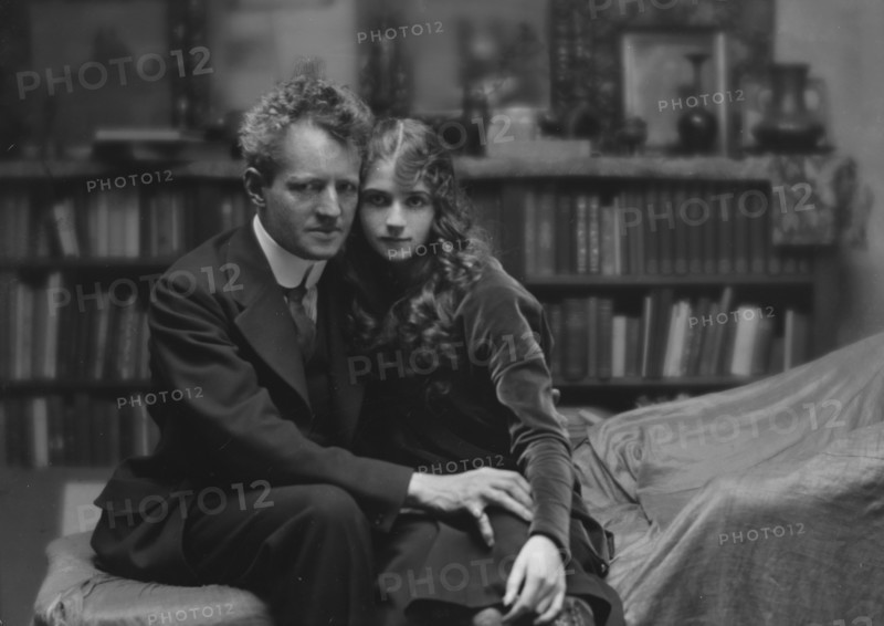 Arnold Genthe seated next to a woman friend in his studio in San Francisco, between 1896 and 1911. Creator: Arnold Genthe.