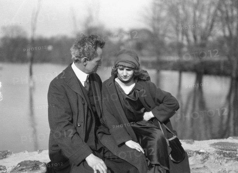 Arnold Genthe seated outdoors with a woman friend, between 1896 and 1942. Creator: Arnold Genthe.