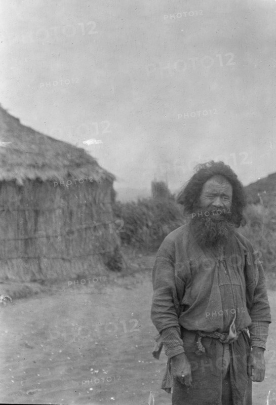 Ainu man standing outside, 1908. Creator: Arnold Genthe.