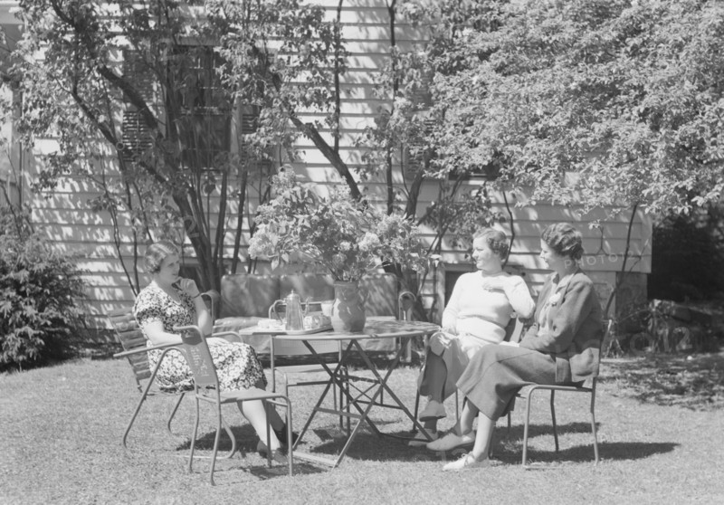 Mrs. Mary Benson and two identified women seated outdoors at a table, between 1933 and 1942. Creator: Arnold Genthe.