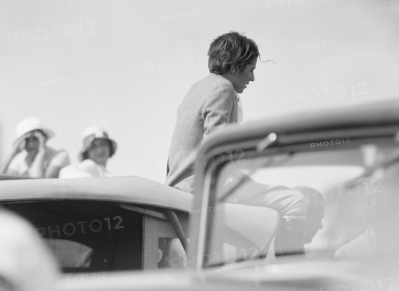 Mrs. Jack Bouvier, seated on a car, 1932. Creator: Arnold Genthe.