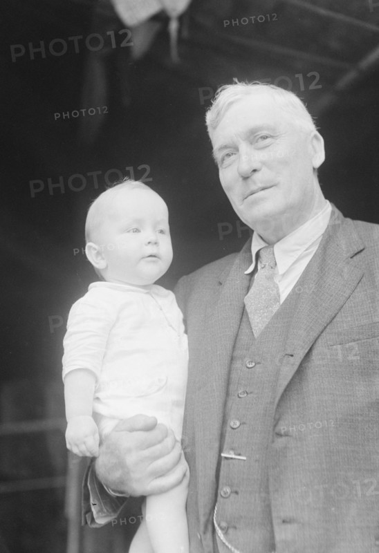 Captain Everett Edwards and baby, portrait photograph, 1933. Creator: Arnold Genthe.