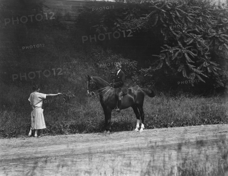 Arnold Genthe riding Chesty, between 1911 and 1936. Creator: Arnold Genthe.