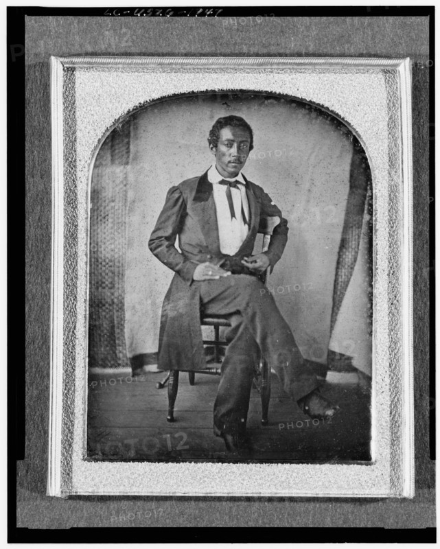R. McGill, full-length portrait, seated in chair, facing front, with..., between 1840 and 1860. Creator: Unknown.