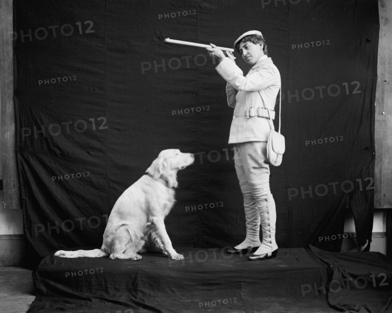 Billy and his mistress in hunting poses, between 1895 and 1910. Creator: Unknown.
