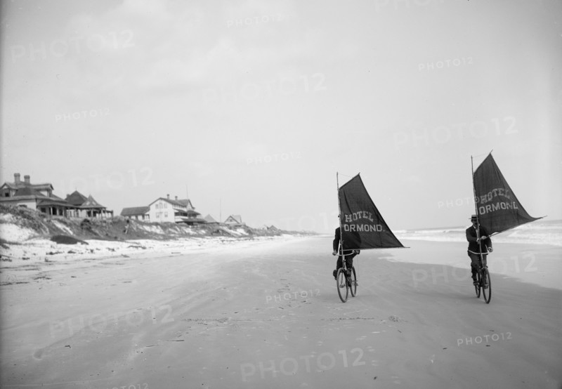 Sailing bicycles on the beach, Ormond, Fla., between 1900 and 1910. Creator: Unknown.