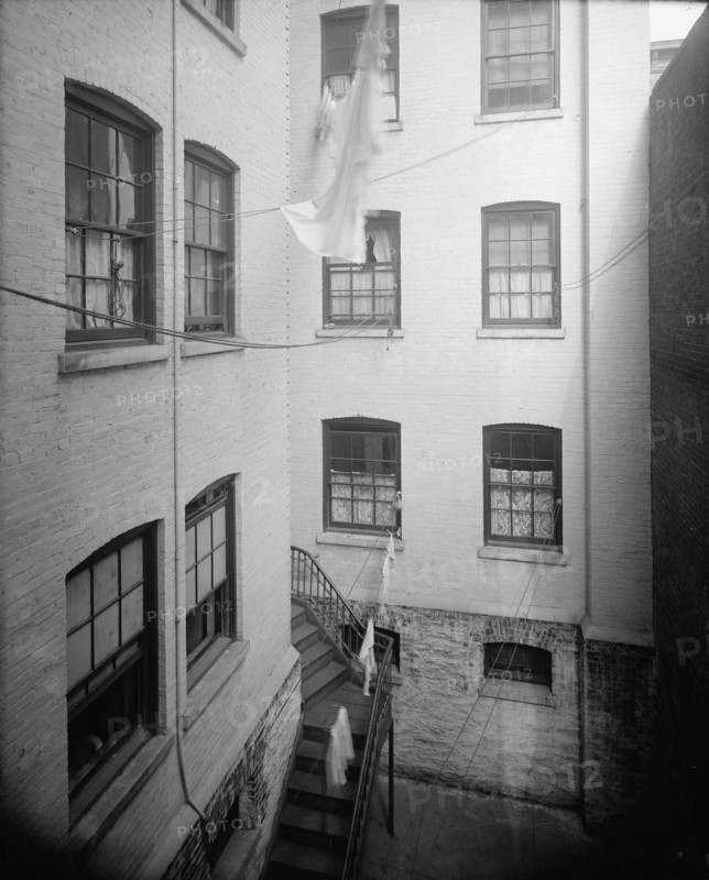 Court of tenement, New York City, between 1900 and 1910. Creator: Unknown.