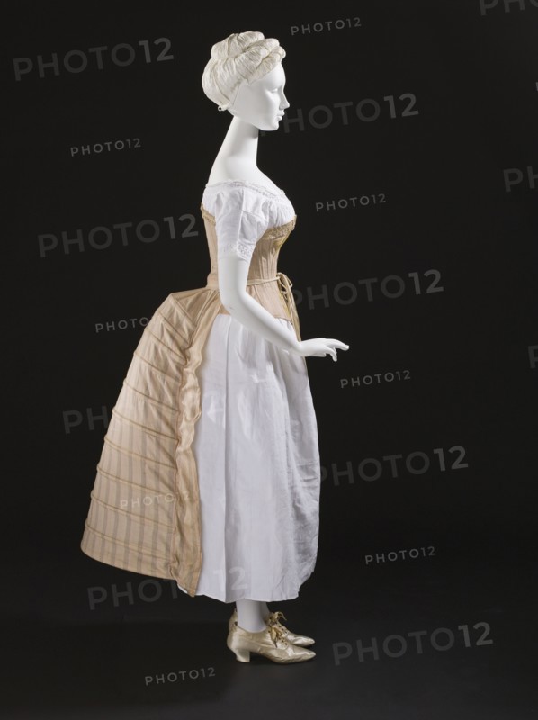 Woman's bustle, England, c.1885. Corset: c.1865-75, Chemise: c.1850-70, Shoes: 1875-1900. Creator: Unknown.