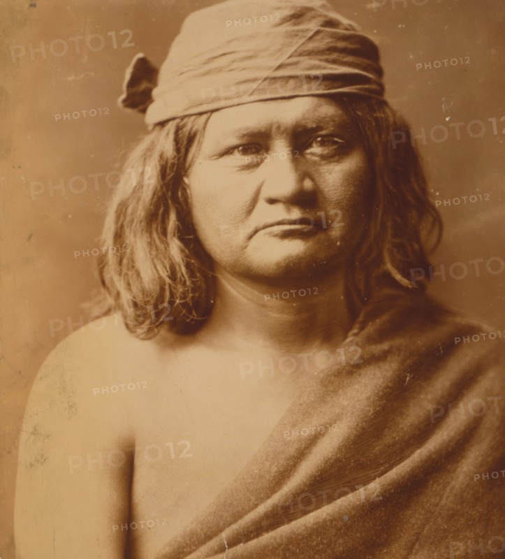 Native man, head-and-shoulders portrait, facing front, c1903. Creator: Edward Sheriff Curtis.