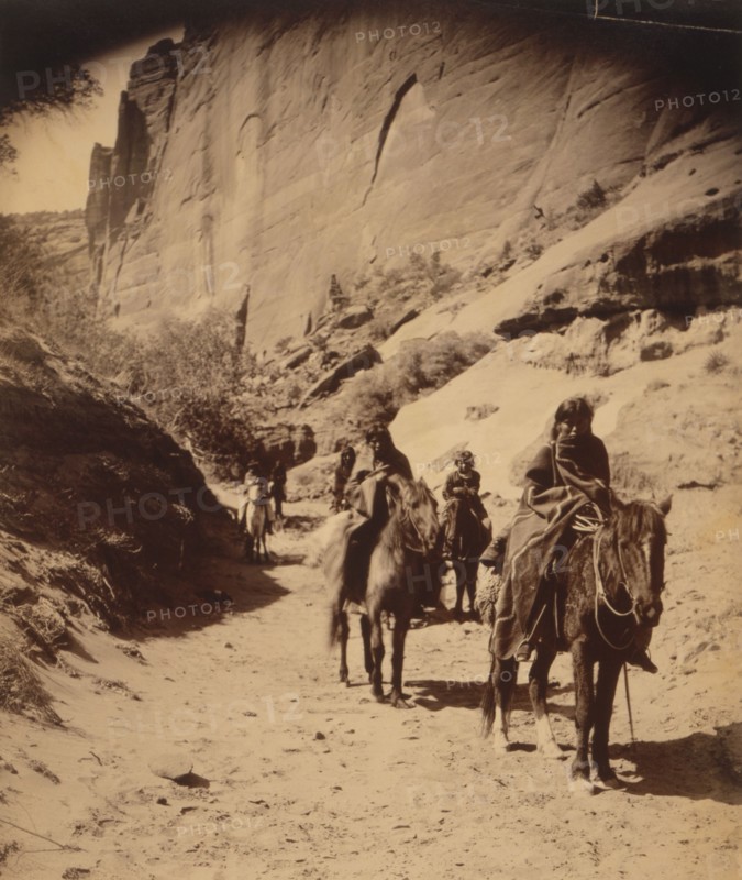 Band of mounted Navahos passing through Cañon, c1904. Creator: Edward Sheriff Curtis.