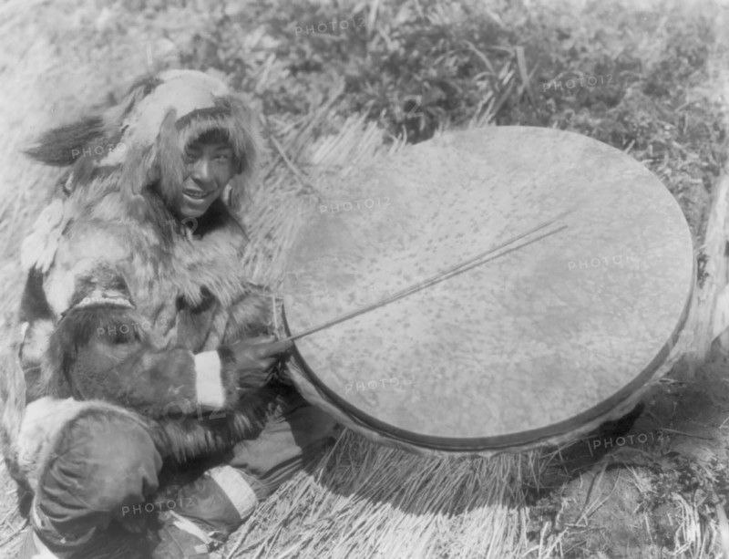 The drummer-Nunivak, c1929. Creator: Edward Sheriff Curtis.