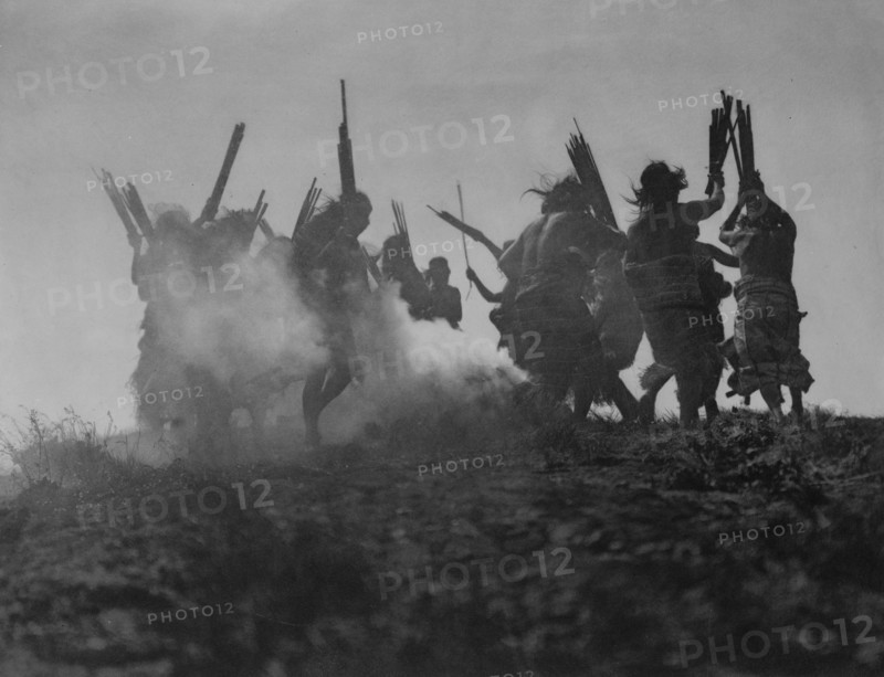 Dancing to restore an eclipsed moon, c1914. Creator: Edward Sheriff Curtis.