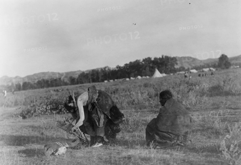 Offering pipe to the skull-Cheyenne, c1910. Creator: Edward Sheriff Curtis.