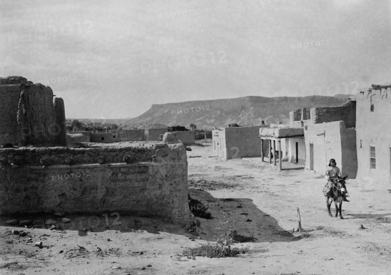 A street scene in San Ildefonso Pueblo, 1905, c1905. Creator: Edward Sheriff Curtis.