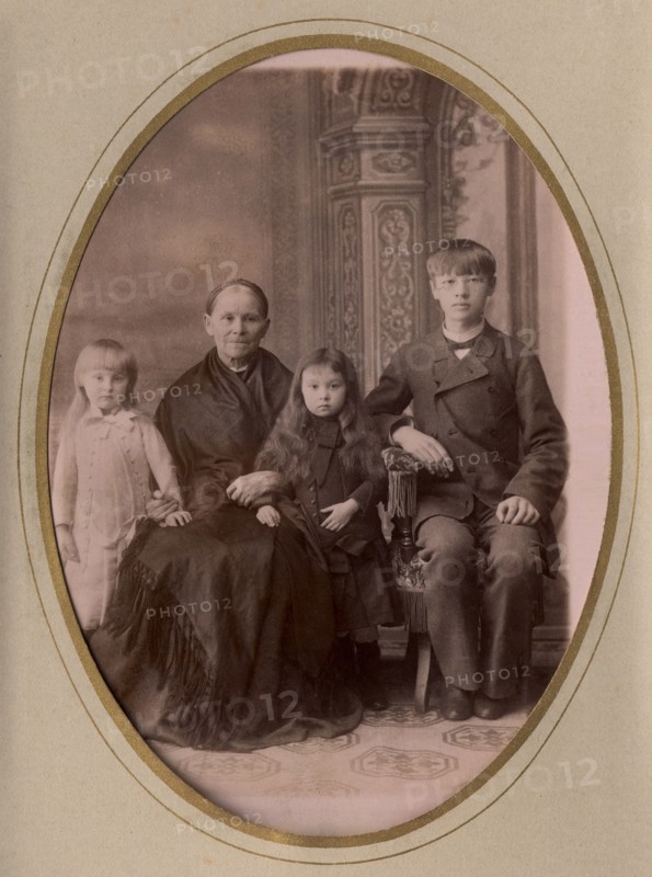 An elderly woman, a young man in a civilian suit and two.,, late 19th cent - early 20th cent. Creator: PA Milevskii.