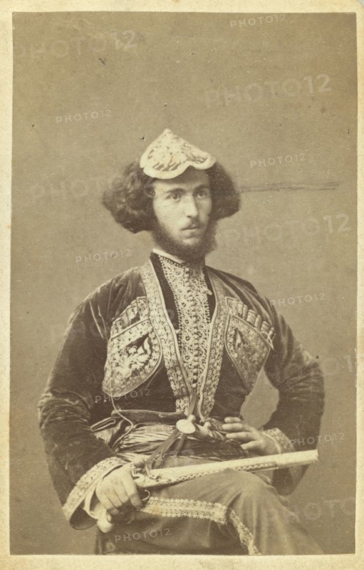 Three-quarter portrait of man, seated, facing right, between 1870 and 1886. Creator: Unknown.