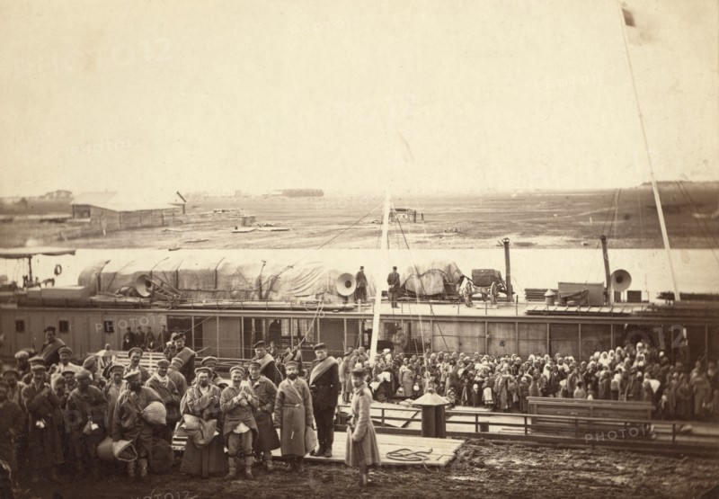 Party of exiles and convicts embarking on river barge at Tumen [ie, Tiumen]..., between 1885 and 86. Creator: Unknown.