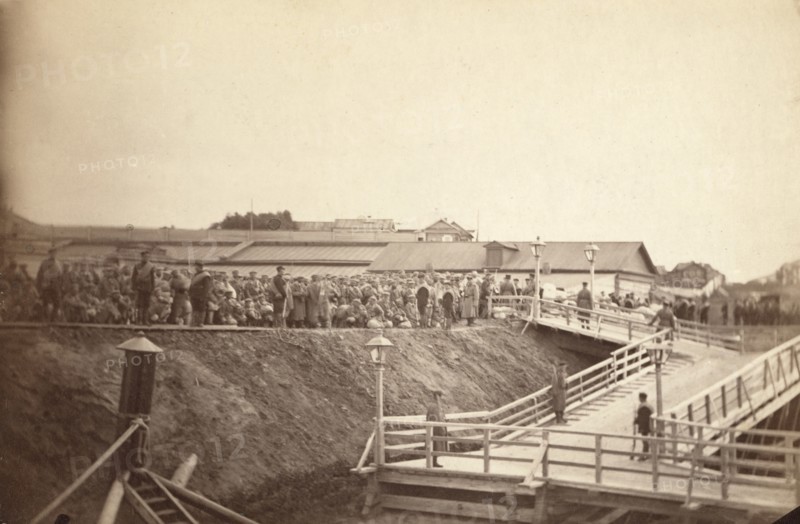 Group of convicts at head of inclined plane leading to barge, between 1885 and 1886. Creator: Unknown.