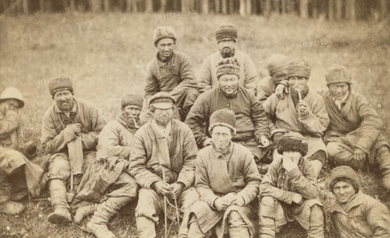 Group portrait of convicts seated in a field, between 1880 and 1886. Creator: Unknown.